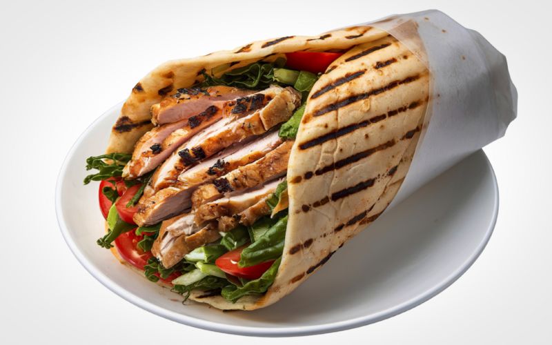 Homemade chicken shawarma wrap with garlic sauce and pita bread