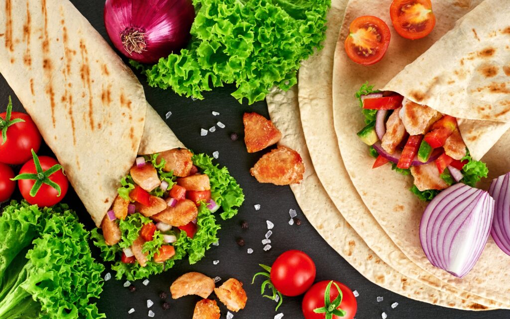 Shawarma vs gyro taste difference with chicken shawarma wrap and Greek gyro sandwich