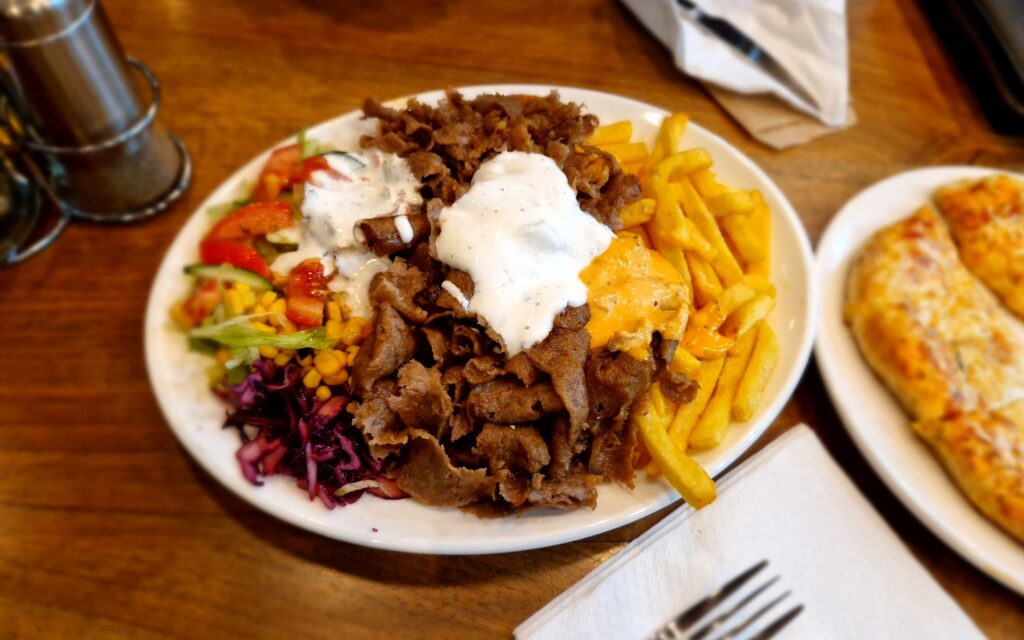 Vertical rotisserie shawarma gyro doner meat cooking on spit street food style