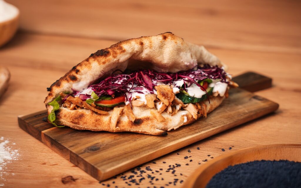 Middle Eastern shawarma gyro distinction with spices and grilled meat slices