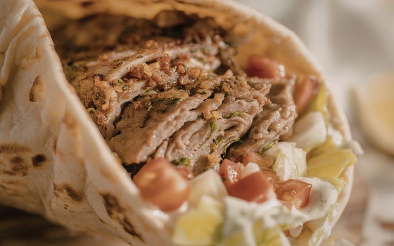 lavash bread shawarma wrap being rolled step by step