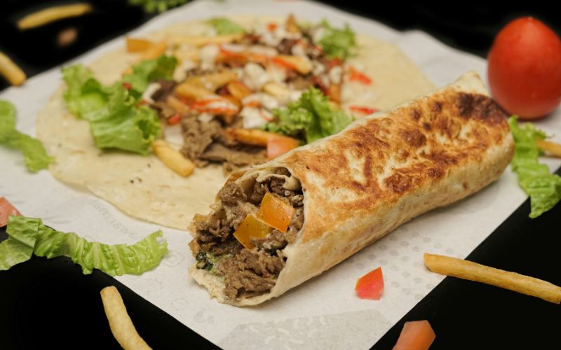 Pan-fried homemade beef shawarma cooking in cast iron pan