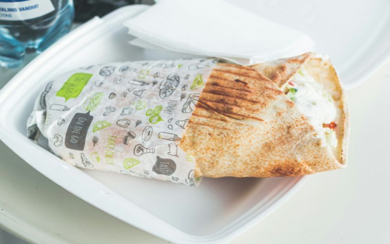 Custom shawarma paper wrapped around a fresh chicken shawarma