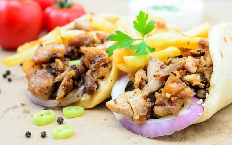 What Is Shawarma Sauce? Chicken shawarma wrap topped with creamy white garlic sauce